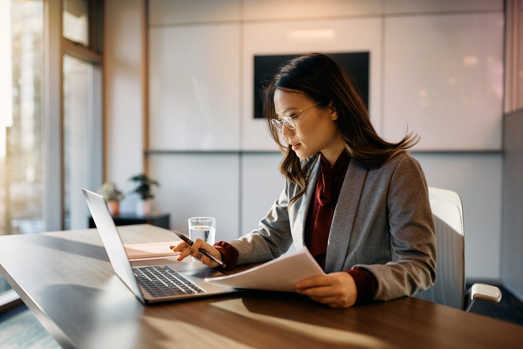 asian-businesswoman-using-laptop-while-analyzing-r-2023-02-17-03-03-35-utc-scaled asian-businesswoman-using-laptop-while-analyzing-r-2023-02-17-03-03-35-utc-scaled